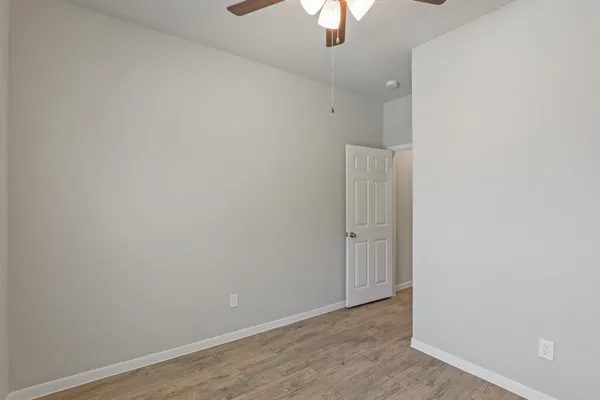an empty room with a empty space and a ceiling fan