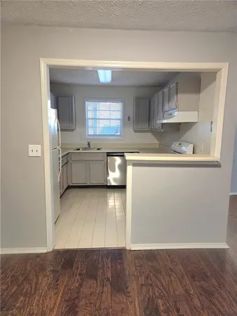 a kitchen with granite countertop a stove and cabinets