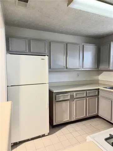 a kitchen with cabinets and white appliances