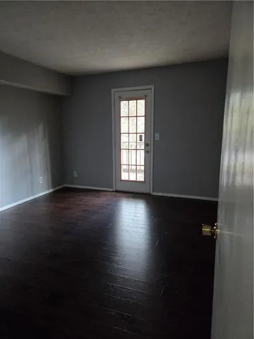 a view of room with window and wooden floor