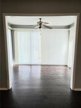 a view of a room with wooden floor and window