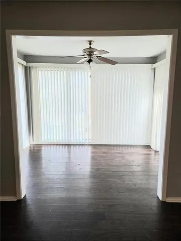 a view of a room with wooden floor and window