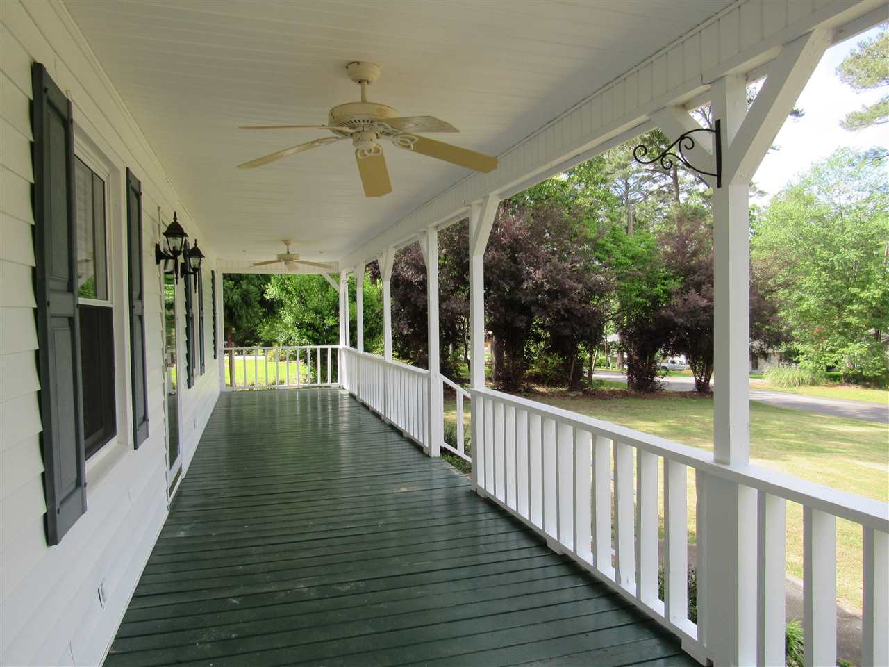 373 Skinner Road Four Oaks, NC 27524 - Photo 12 of 25 44' rocking chair porch with view of lake Front porch