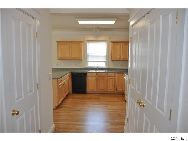 16509 Knox Run Road Huntersville, NC 28078 - Photo 15 of 16 a kitchen with stainless steel appliances granite countertop a stove a sink and a refrigerator with wooden floors