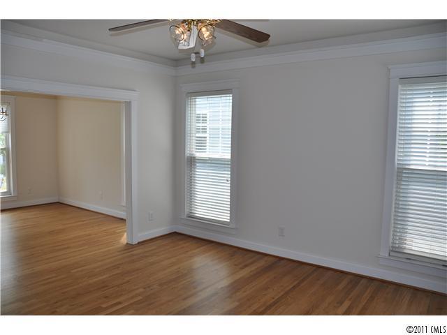 16509 Knox Run Road Huntersville, NC 28078 - Photo 7 of 16 an empty room with wooden floor and windows