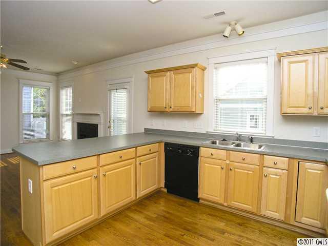 16509 Knox Run Road Huntersville, NC 28078 - Photo 9 of 16 a kitchen with granite countertop white cabinets white appliances sink and window