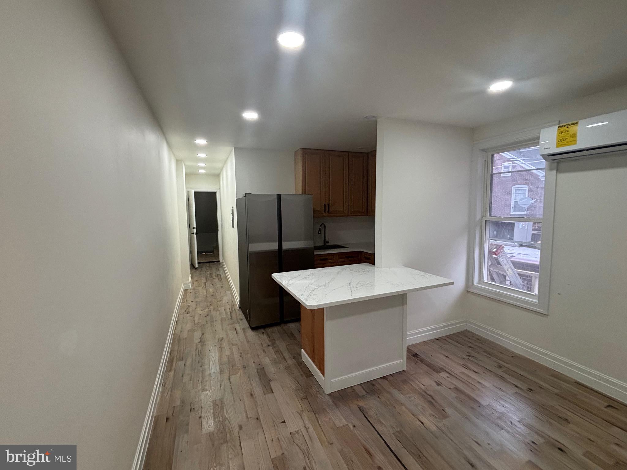 1120 Elm Street, Unit 2R Reading, PA 19604 - Photo 3 of 7 a kitchen with a sink a refrigerator and a stove top oven