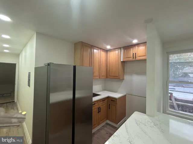 a kitchen with stainless steel appliances a refrigerator and a sink