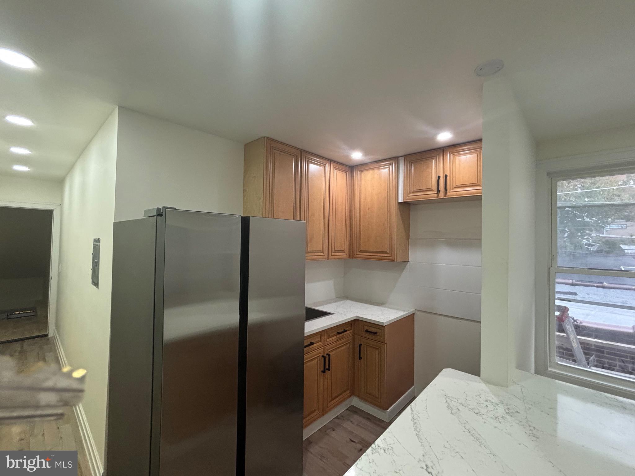 1120 Elm Street, Unit 2R Reading, PA 19604 - Photo 4 of 7 a kitchen with stainless steel appliances a refrigerator and a sink