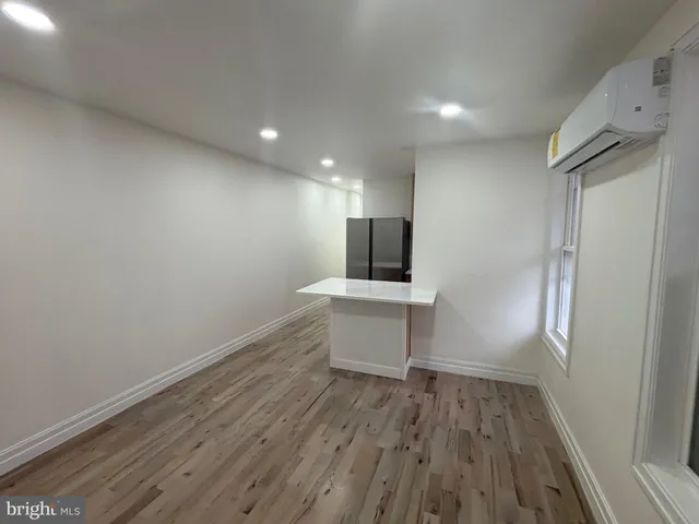 a view of a kitchen with a sink and a refrigerator