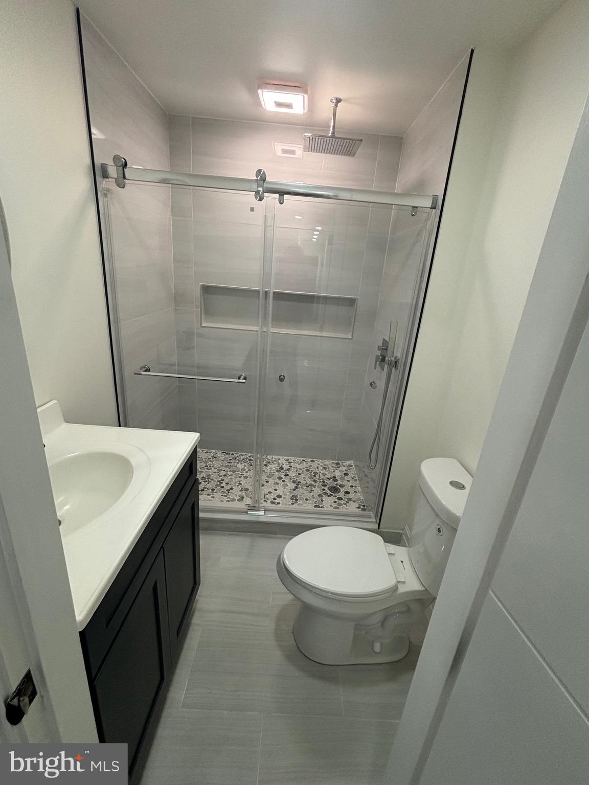 1120 Elm Street, Unit 2R Reading, PA 19604 - Photo 6 of 7 a bathroom with a sink a toilet and shower