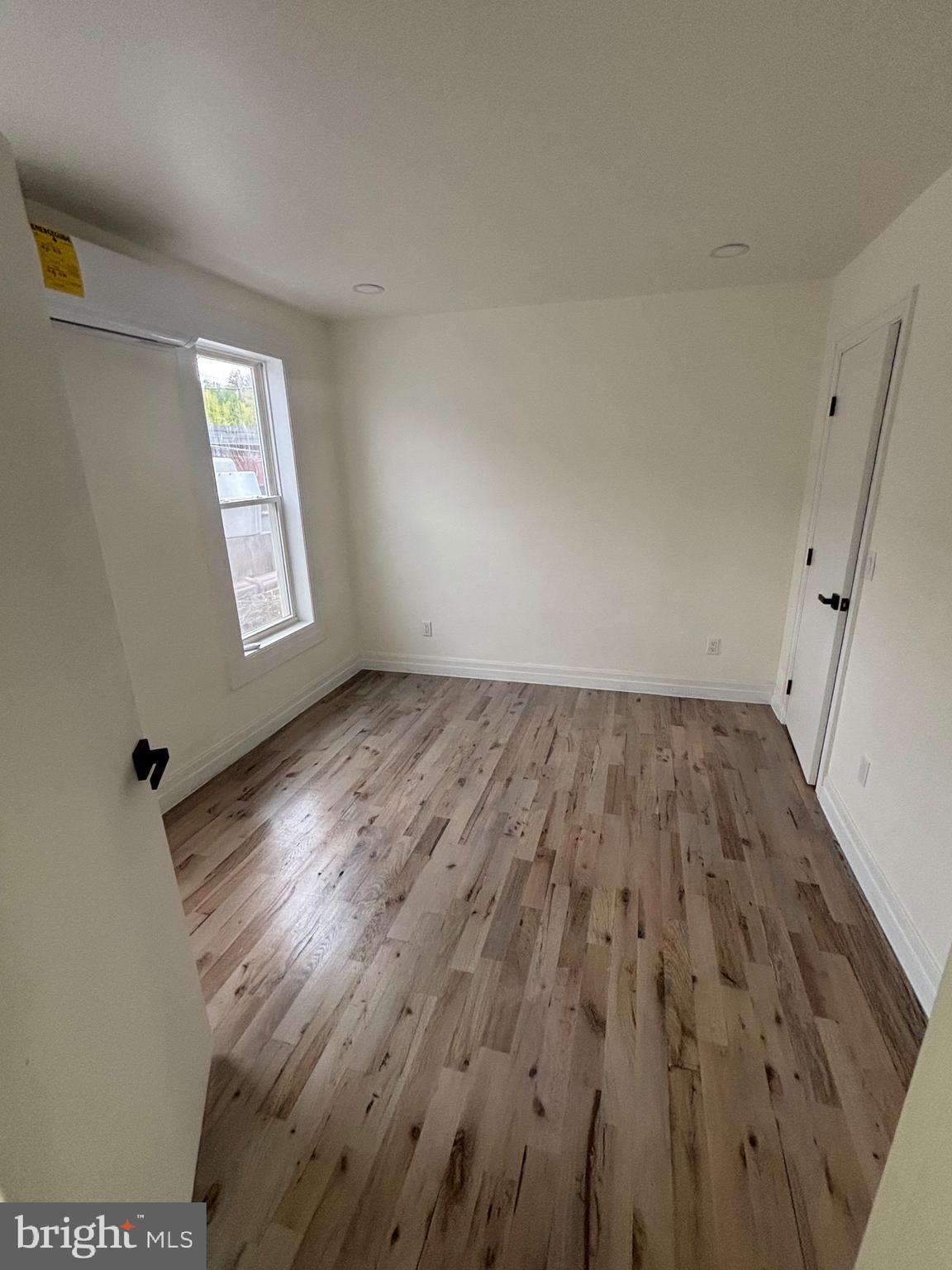 1120 Elm Street, Unit 2R Reading, PA 19604 - Photo 7 of 7 an empty room with wooden floor and windows