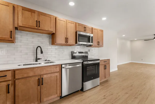 a kitchen with sink a microwave and stove