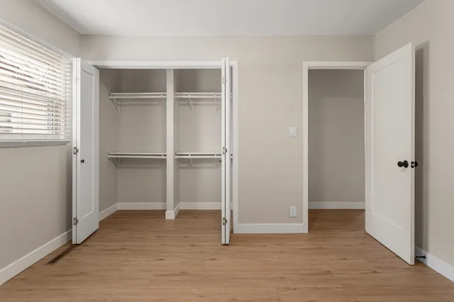 a view of a livingroom with wooden floor and closet area