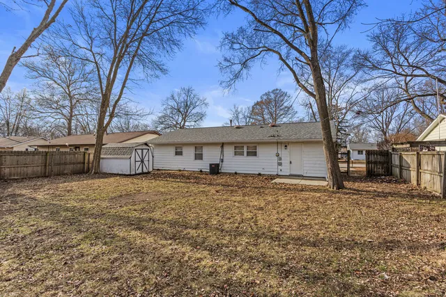 a large house with a large tree in front of it