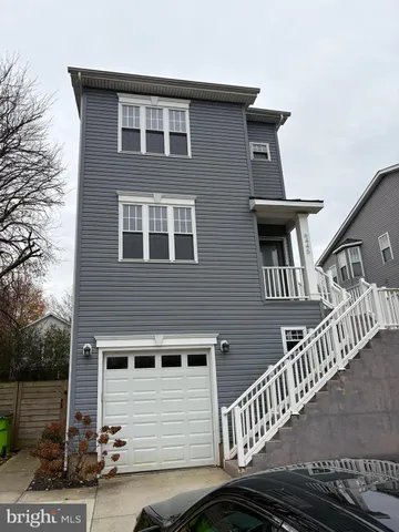 a front view of a house with iron stairs