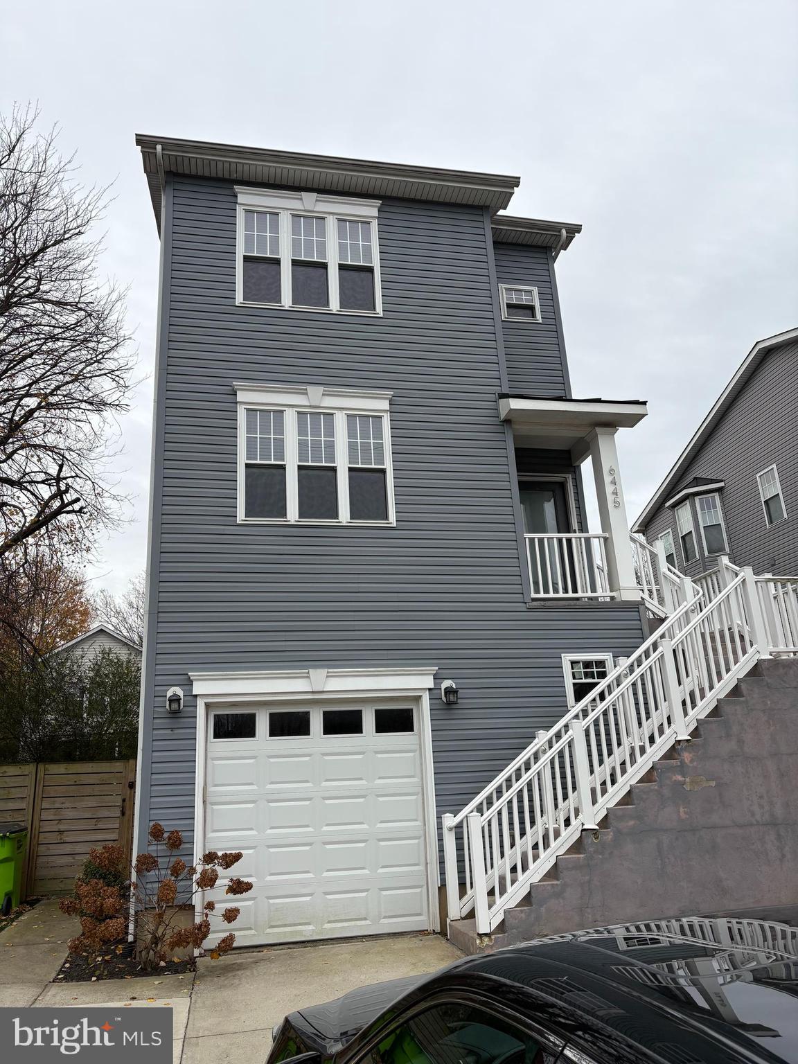 a front view of a house with iron stairs