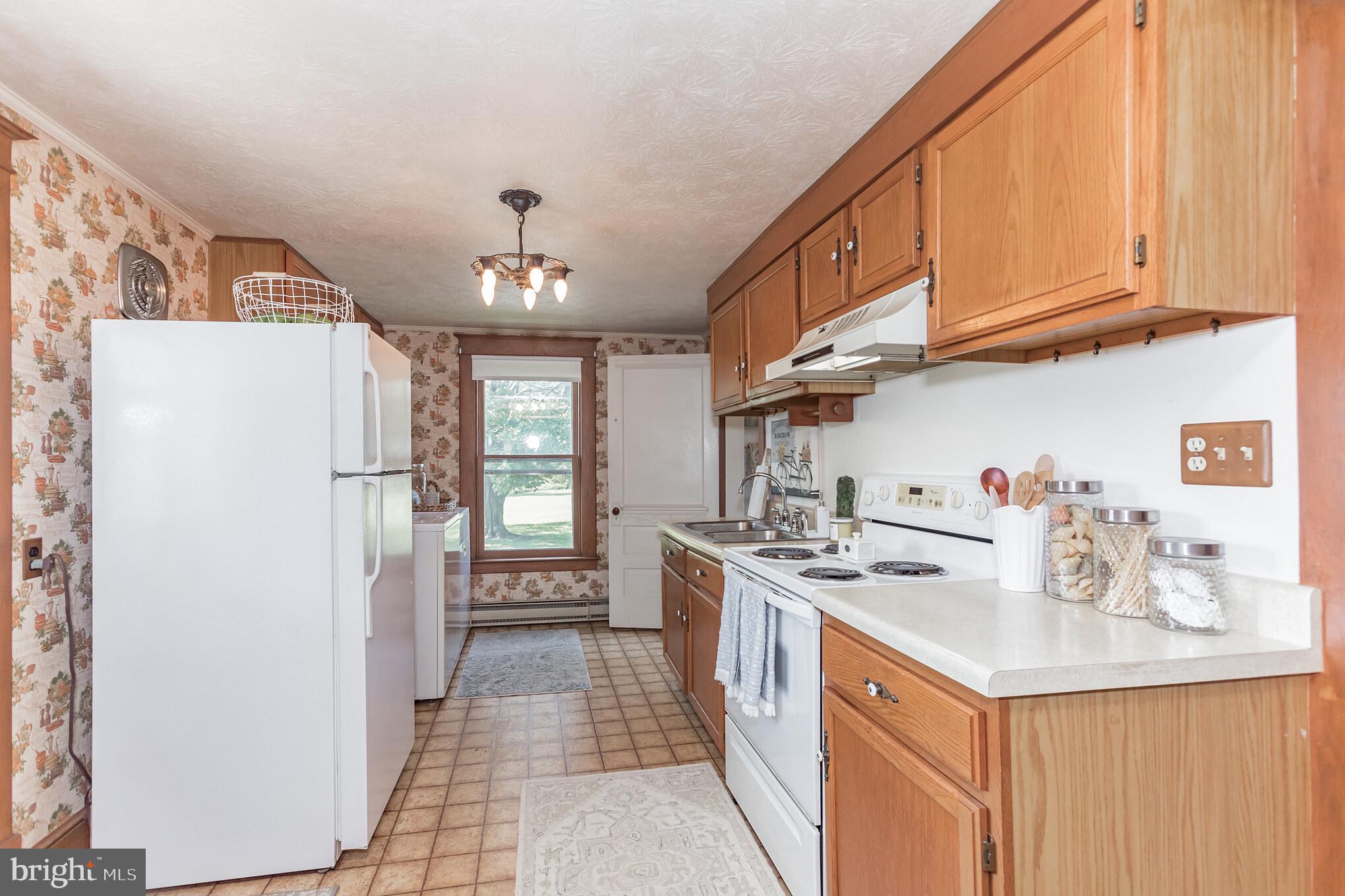 28814 Kemptown Road Damascus, MD 20872 - Photo 12 of 49 a kitchen with a sink stove and refrigerator