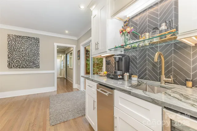 a kitchen with a sink and a wooden floor