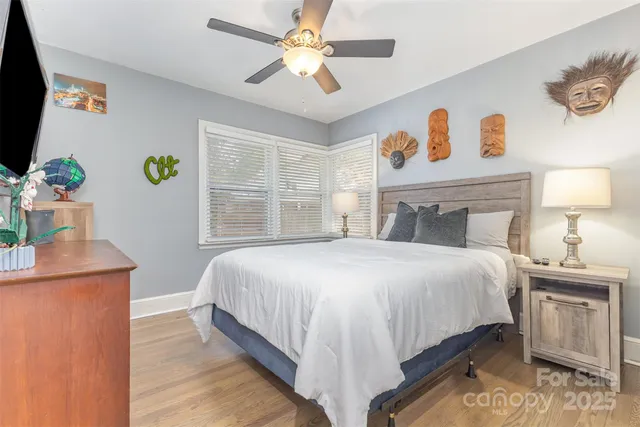 a bedroom with a bed and a potted plant