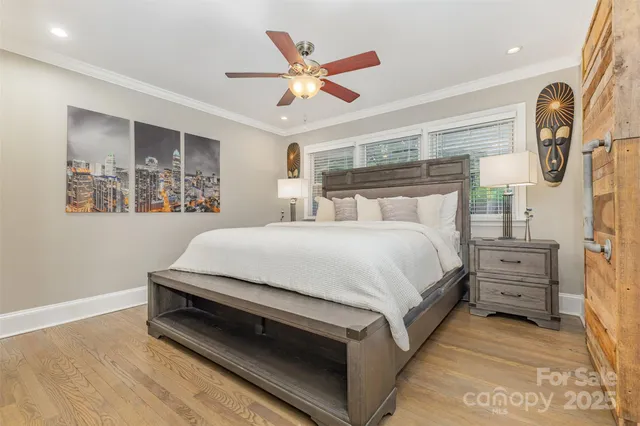 a spacious bedroom with a bed and ceiling fan