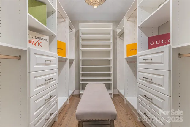 a view of walk in closet with empty racks