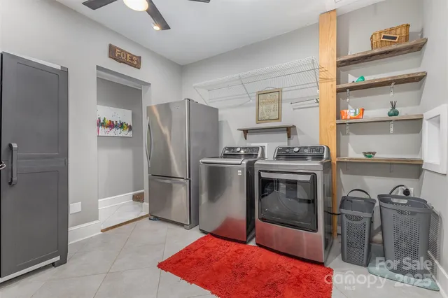 a kitchen with granite countertop a refrigerator and a stove top oven