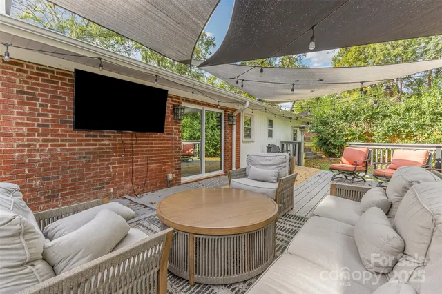 a outdoor living space with furniture and a fireplace