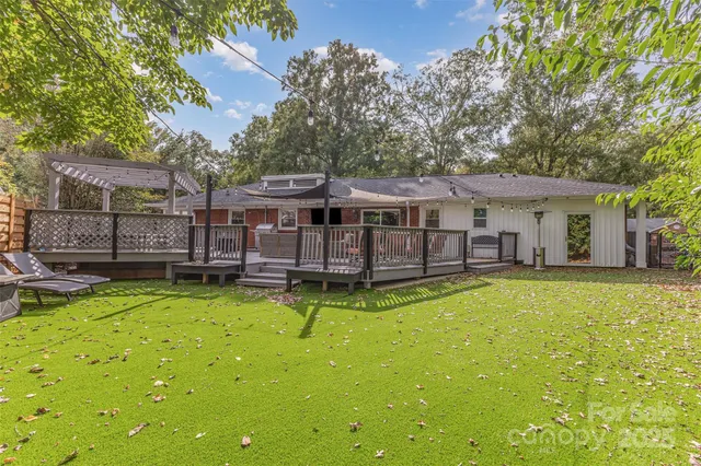 a view of a house with swimming pool and sitting area