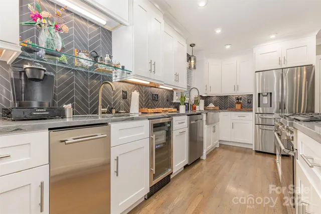 a kitchen with white cabinets and white appliances