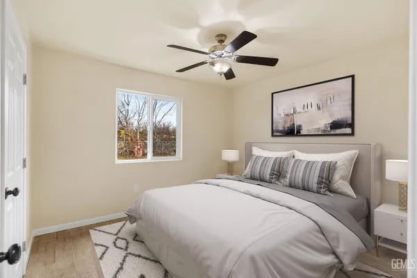 a bedroom with a bed and a painting on the wall