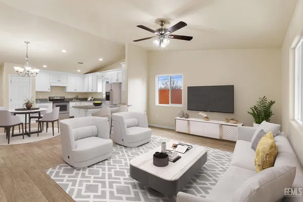 a living room with furniture kitchen view and a flat screen tv