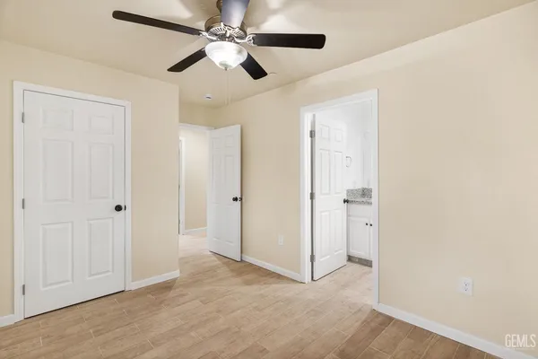 a view of an empty room with a ceiling fan