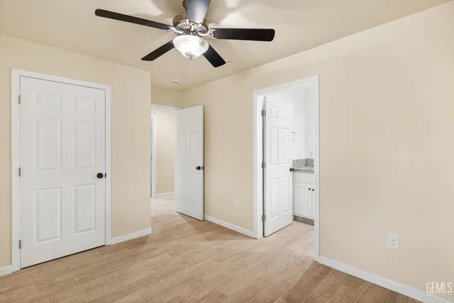 a view of an empty room with a ceiling fan