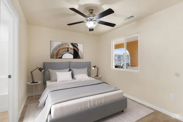 a bedroom with a large bed and a chandelier