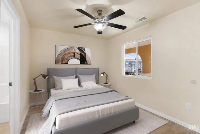 a bedroom with a large bed and a chandelier