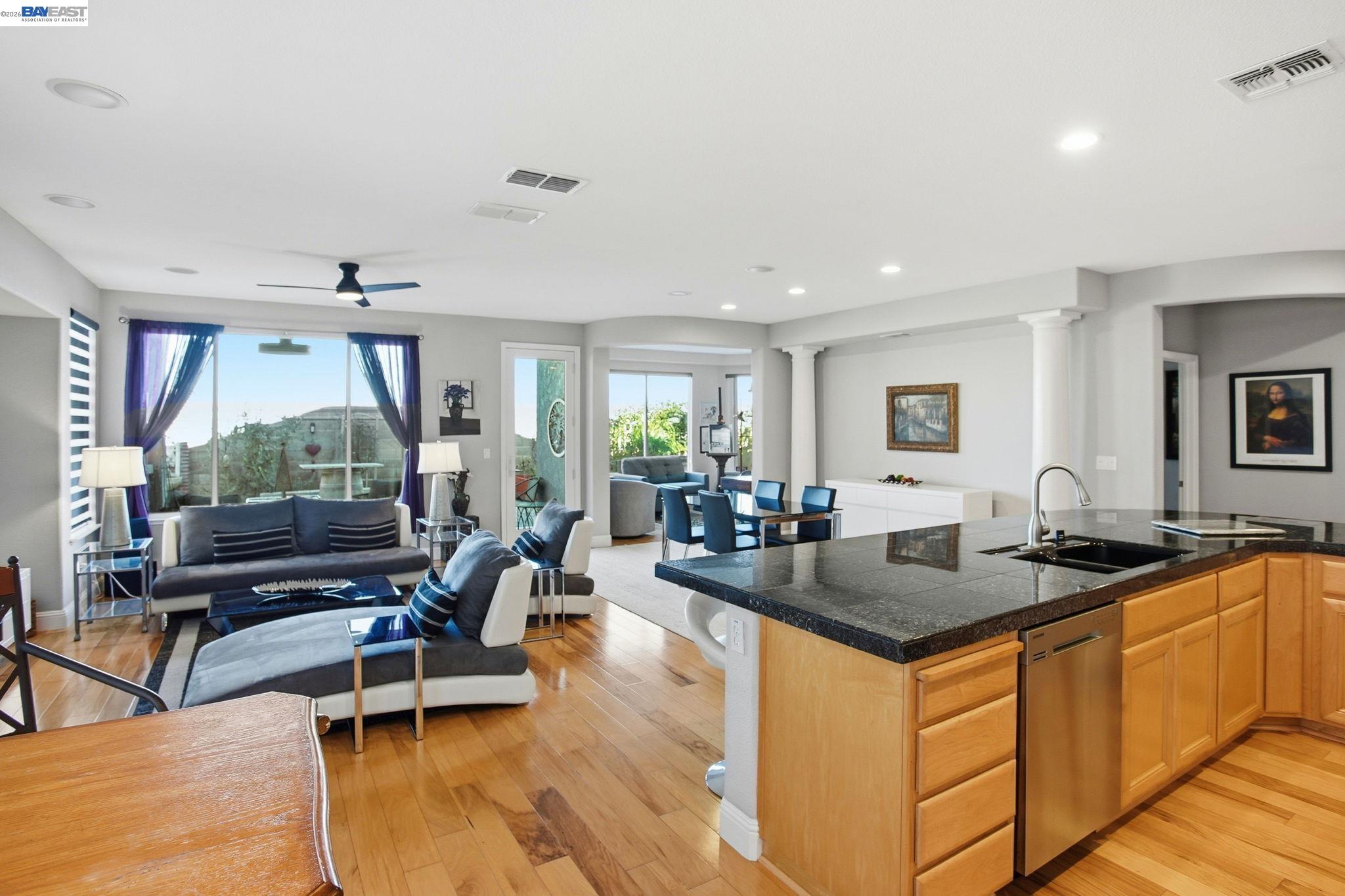 a living room with granite countertop furniture a rug and a chandelier