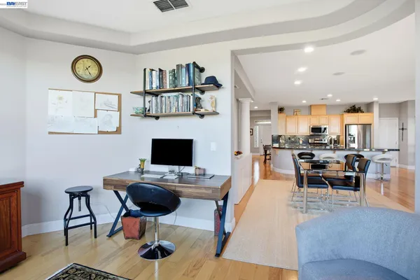 a dining room with wooden floor and a table