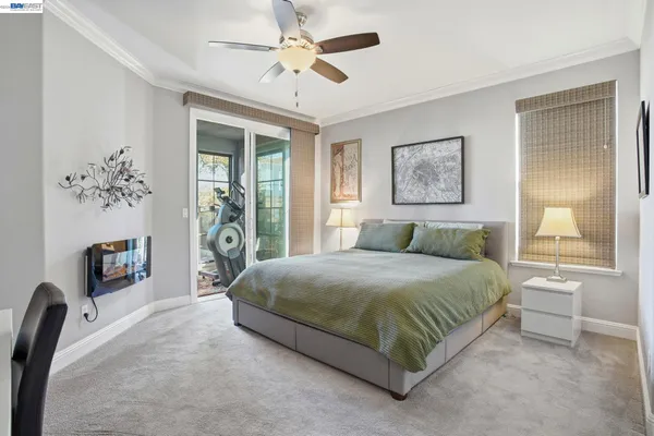 a bedroom with a large bed and a chandelier