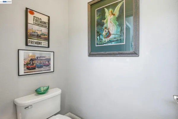 a white toilet sitting next to a bathroom sink