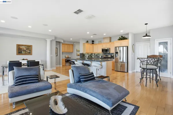 a living room with furniture and kitchen view