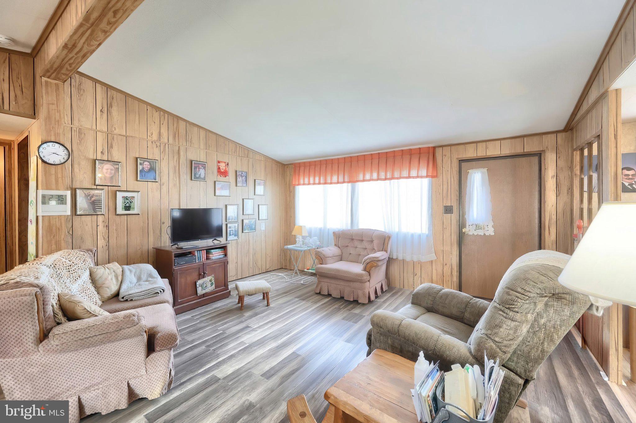 77 2nd Avenue Hanover, PA 17331 - Photo 16 of 22 a living room with furniture a flat screen tv and a large window