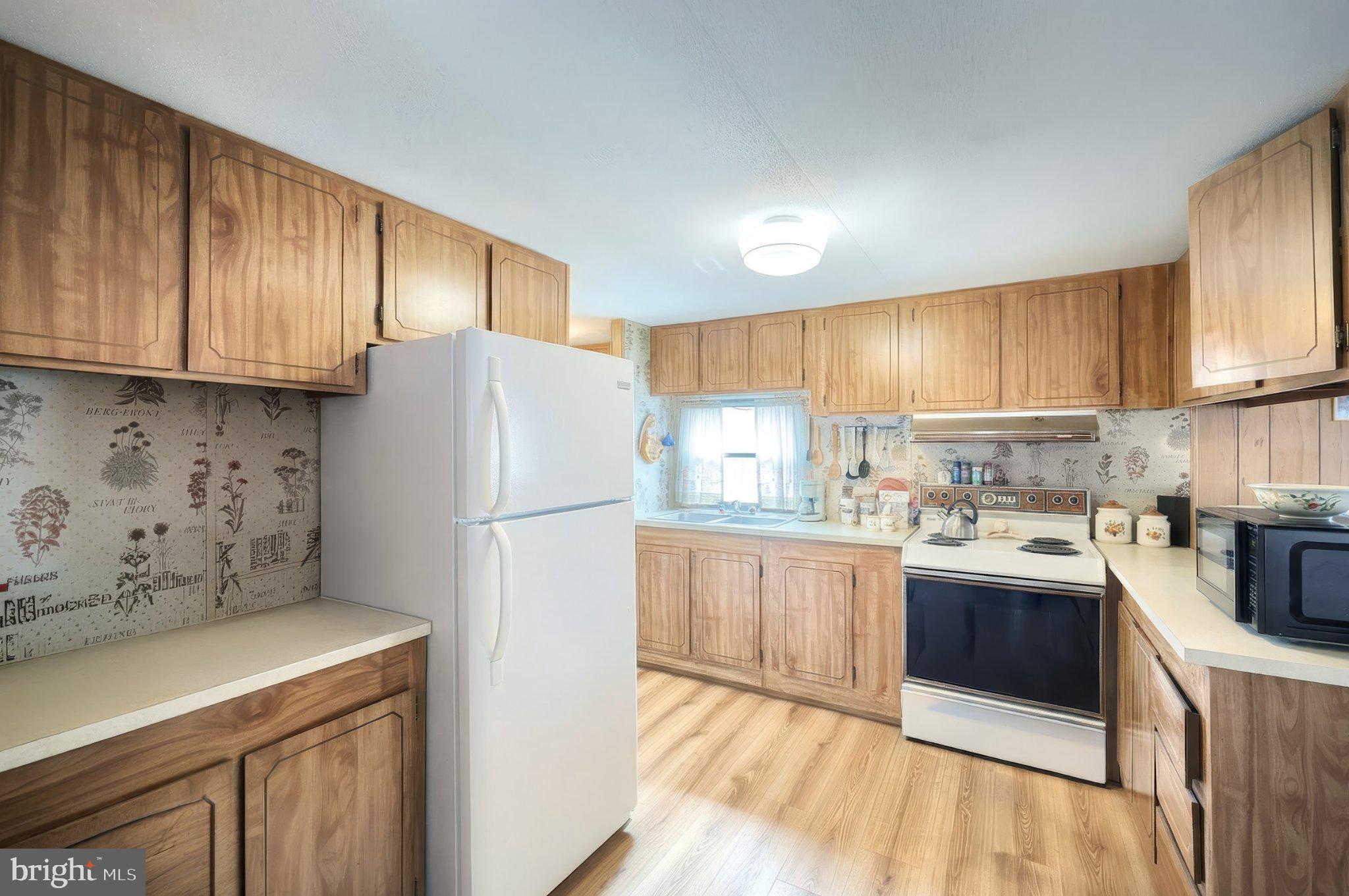 77 2nd Avenue Hanover, PA 17331 - Photo 10 of 22 a kitchen with refrigerator a stove a sink and cabinets