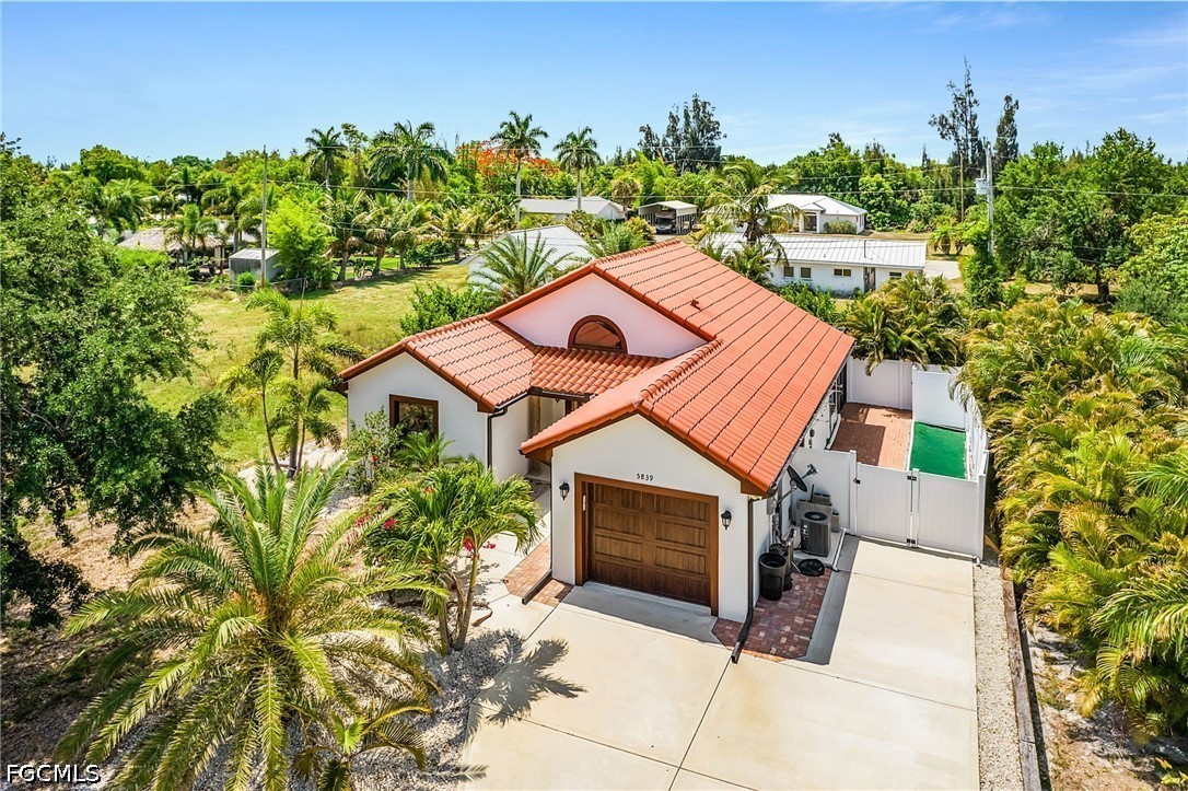 an aerial view of a house with a yard and garage