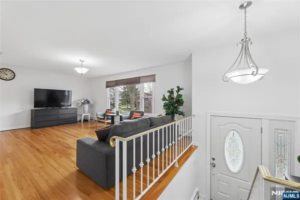 a living room with furniture a flat screen tv and a window