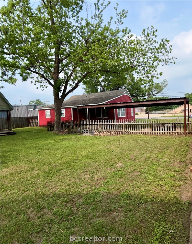 421 South Commerce Street Centerville, TX 75833 - Photo 12 of 23 a front view of a house with a garden