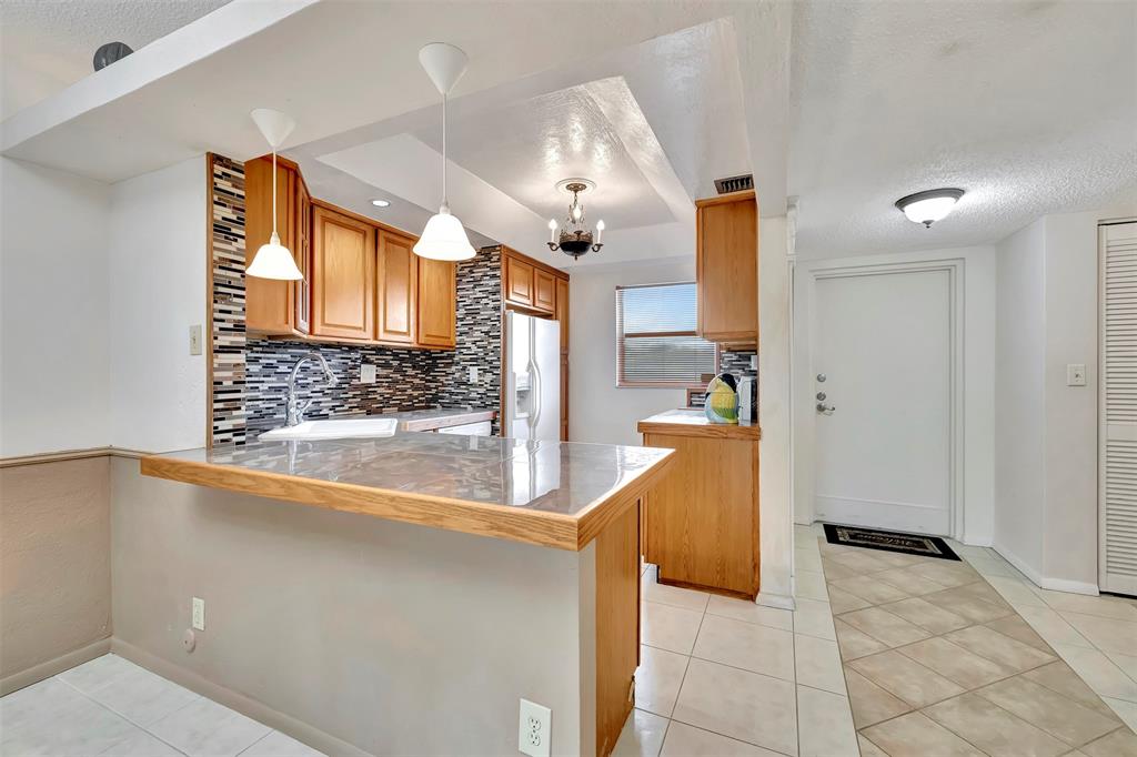 8380 Sands Point Boulevard, Unit J306 Tamarac, FL 33321 - Photo 13 of 33 a view of kitchen with furniture and a window
