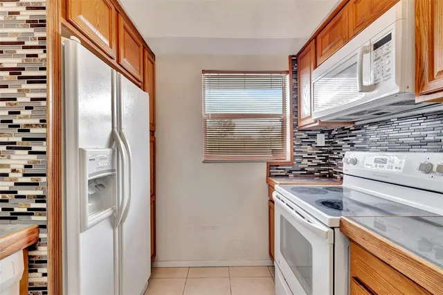 a view of a kitchen with granite countertop a sink and a window