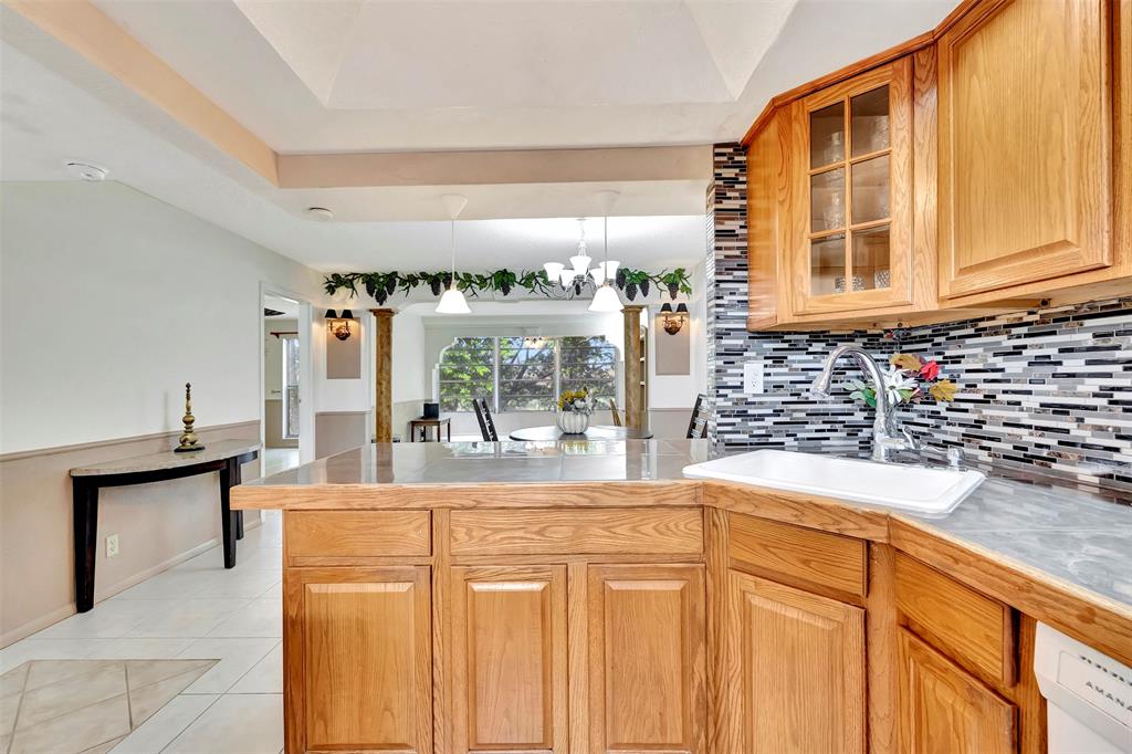 8380 Sands Point Boulevard, Unit J306 Tamarac, FL 33321 - Photo 16 of 33 a view of a kitchen with granite countertop a sink and a window