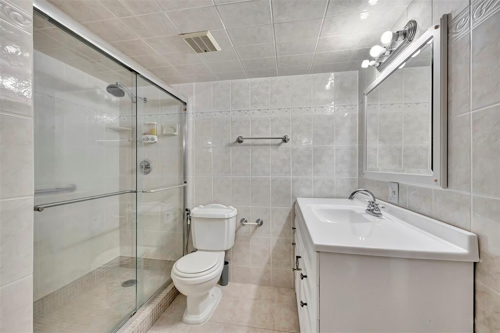 8380 Sands Point Boulevard, Unit J306 Tamarac, FL 33321 - Photo 23 of 33 a bathroom with a sink toilet and shower